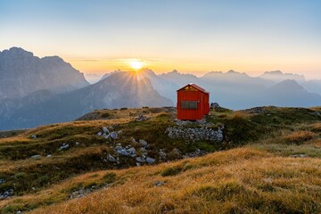 Bivacco Bedin mountain cabin in the Dolomites mountains at sunset in Italy - Powered by Adobe