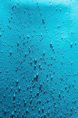 Water drops blue background. Droplet splash rain texture. Drop splash water pattern. Selective focus.