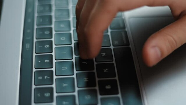 Close up of an young businessman hands busy working on laptop or computer keyboard for send emails and surf on a web browser.
