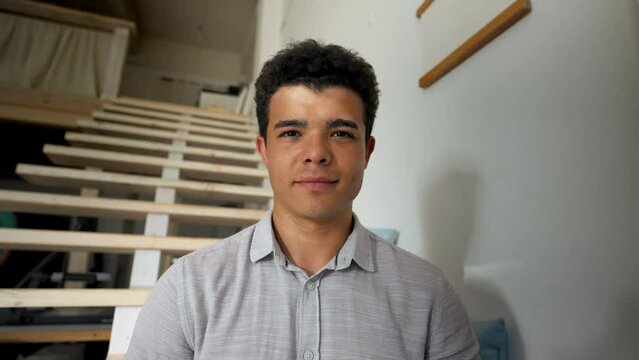 POV of man listening to mentor talking on educational conference via webcam. Student waves head to agree looking in camera against stairs closeup