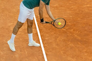 Man in serve position on a clay tennis court.
