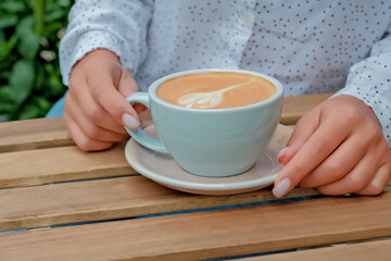 female hands hold a cup of coffee. cup of coffee close-up