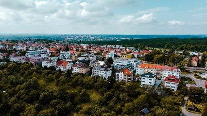 Aerial view of Prague suburbs in afternoon light against blue cloudy sky