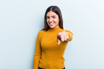 Young caucasian woman isolated on blue background cheerful smiles pointing to front.