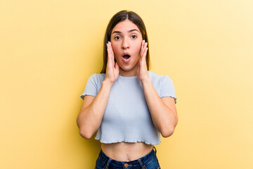 Young caucasian woman isolated on yellow background surprised and shocked.