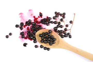 Elderberries, elder berries pile in wooden spoon, isolated on white, top view