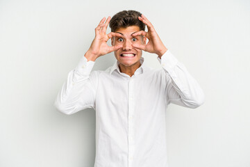 Young caucasian man isolated on white background keeping eyes opened to find a success opportunity.