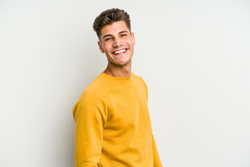 Young caucasian man isolated on white background confident keeping hands on hips.