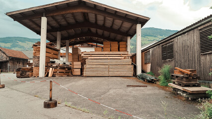 Big storage of wooden bricks in the village in mountains