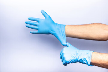 two human hands in blue nitrile surgical gloves, professional medical safety and hygiene for surgery and medical examination on a white background. Lots of empty space
