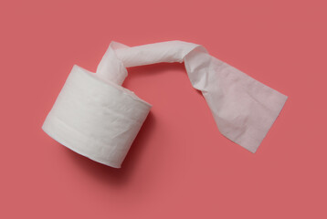 Roll of toilet paper on a pink background.