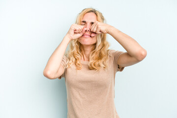 Young caucasian woman isolated on blue background whining and crying disconsolately.