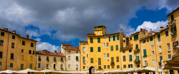 The famous Piazza dell'Anfiteatro (Amphitheater Square) in the historic center of Lucca, with houses, shops and restaurants built over ancient roman arena ruins