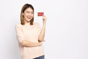 Happy young Asian woman smiling and showing red credit card for paying online business isolated on white background