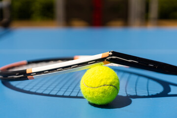 Broken tennis racket on clay tennis court