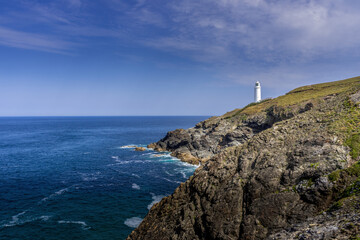 Fototapeta na wymiar The Lighthouse standing above the Rocky Cliffs on Trevose Head in Cornwall.