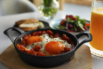 Tasty Shakshouka served on white table. Traditional Arabic dish
