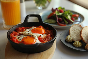 Tasty Shakshouka served on white table. Traditional Arabic dish