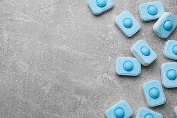 Water softener tablets on grey table, flat lay. Space for text