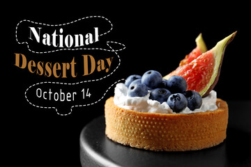 National Dessert Day, October 14. Tartlet with blueberries and figs on black cake stand dark background, closeup