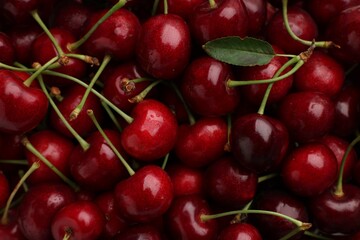 Ripe sweet cherries as background, top view