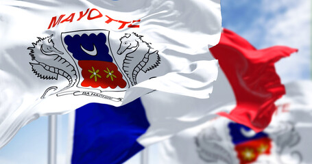 Flags of Mayotte waving in the wind with national flag of France on a clear day