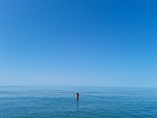 Fototapeta premium Precious image of a woman in the vastness of the ocean