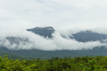 The Beautiful View of Sahyadri Mountain Range, Clouds Touching Hills and Hut Near The Hill, 