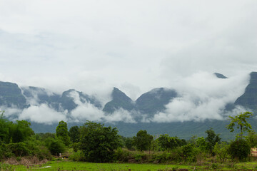 Fototapeta na wymiar The Beautiful View of Sahyadri Mountain Range, Clouds Touching Hills and Hut Near The Hill, 