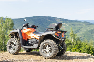 Fototapeta na wymiar ATV Quad Bike in front of mountains landscape.