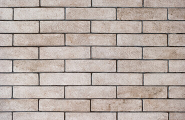 Background of a wall of gray and dirty bricks close-up