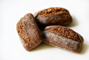 Three rye bread rolls on a white background. Delicious baked bread.