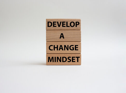 Develop a change mindset symbol. Concept words Develop a change mindset on wooden blocks. Beautiful white background. Business and Develop a change mindset concept. Copy space.