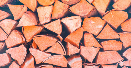 Dry chopped firewood logs. Wooden pile texture. Log background.