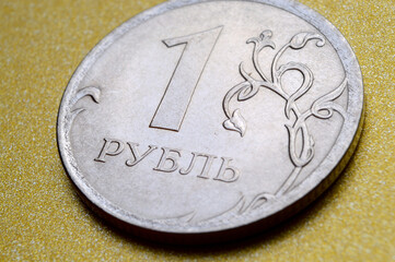Russian rubles in the form of metal coins lie on a yellow background. close-up.