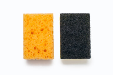 An orange washcloth and a roughened washcloth on a white background in the center of the image. A tool for constant washing dishes and cleaning the house. The concept of cleanliness and order