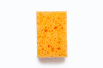 An orange porous washcloth on a white background in the center of the image. Washcloth for washing dishes and daily cleaning in the house. Working tool for cleanliness and care in the house