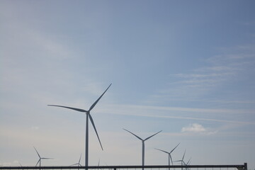 Wind turbines at Amstelmeer, Netherlands. Dutch windmill park in the North sea. Space for text.