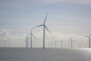 Wind turbines at Amstelmeer, Netherlands. Dutch windmill park in the North sea. Space for text.