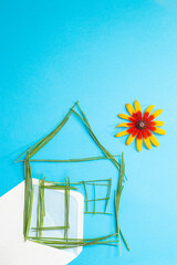 House made of grass straws,  on  a blank envelope, on blue background