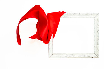 Red satin curtains unveiling a levitating white empty frame