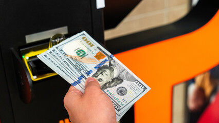 Atm cash bitcoin teller machine. Woman withdraw american dollar bill money. Usd hundred money payment on virtual crypto currency btc wallet. Bitcoin BTC ATM Cash Machine.