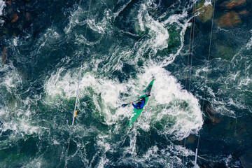 Top view boat of kayaker on mountain rough blue river, extreme sport kayak, aerial drone photo
