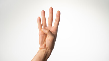 Women's hands gesture counting on fingers four palm side