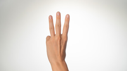 Women's hands count on fingers three back of palms