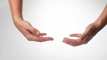 Men's insulated hands hold a heavy object on a white background