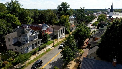 Fototapeta na wymiar Neighborhood homes on main street in Charles Town, West Virginia, WV on a beautiful sunny day.