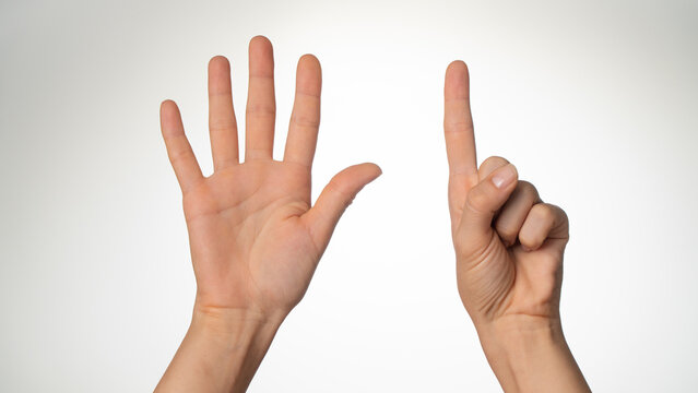 Women's hands gesture counting on fingers six palm side
