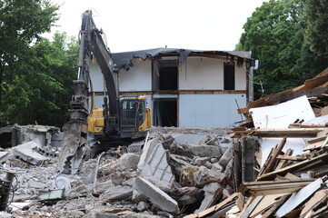 Demolition of a building in deconstruction site with debris, remains and ruined walls