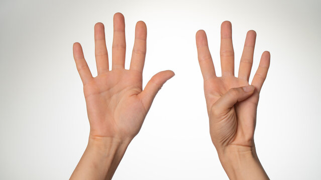 Women's hands gesture counting on fingers nine palm side